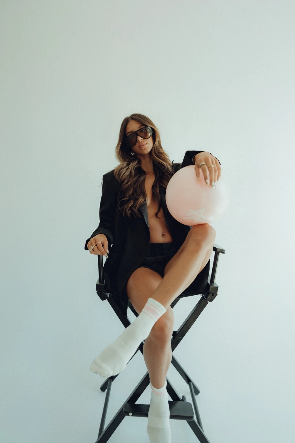 A quiet moment from the Sorè campaign, seated with a Pilates ball.